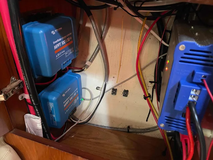 No Agenda Yacht Photos Pics Electrical components inside a 2003 Jeanneau Deck Salon boat, featuring wiring and controllers.