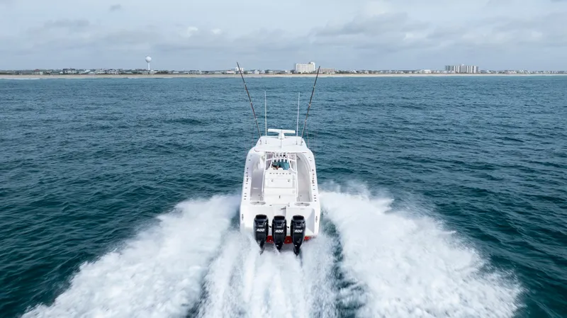  Yacht Photos Pics 2024 SeaHunter 35 Tournament boat cruising on open water, rear view.