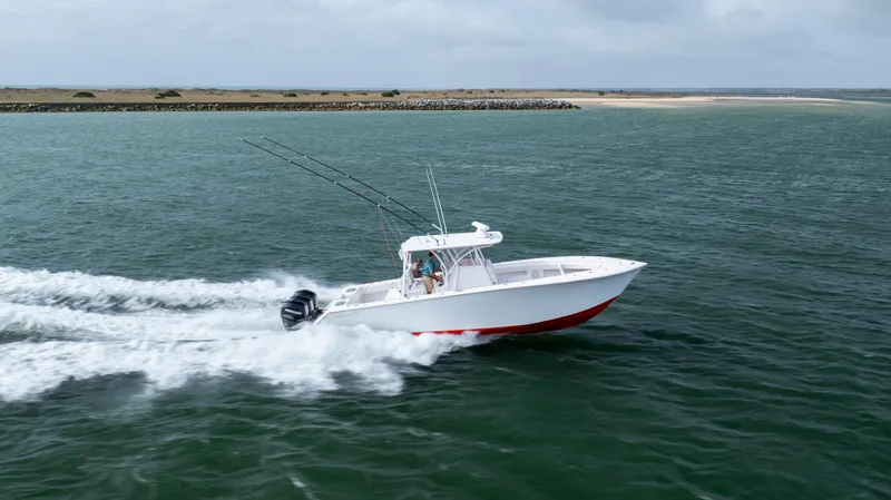  Yacht Photos Pics 2024 SeaHunter 35 Tournament boat speeding on open water, showcasing sleek design and powerful performance.