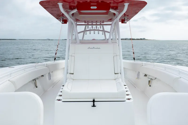  Yacht Photos Pics 2024 SeaHunter 35 Tournament boat with white seating and red canopy on open water.