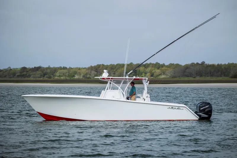 Yacht Photos Pics 2024 SeaHunter 35 Tournament boat on water, side view, with trees in the background.