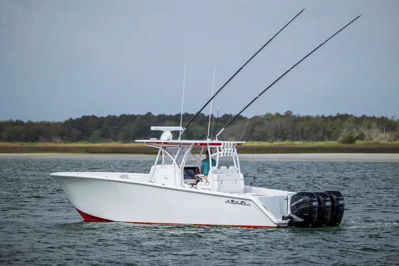  Yacht Photos Pics 2024 SeaHunter 35 Tournament boat cruising on water with fishing rods.