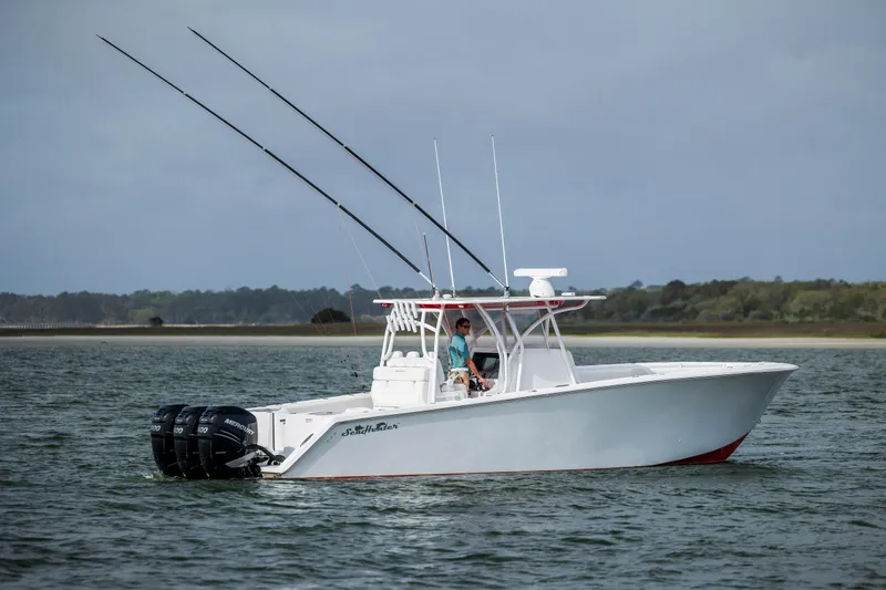  Yacht Photos Pics 2024 SeaHunter 35 Tournament boat on water, featuring dual outboard motors and fishing rods.