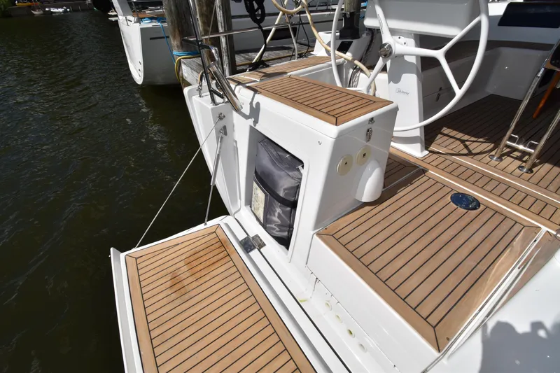 Maelynn Rose Yacht Photos Pics 2019 Hanse 458 yacht deck with wooden flooring and steering wheel.