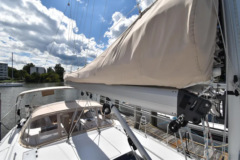Maelynn Rose Yacht Photos Pics 2019 Hanse 458 sailboat with beige sail cover, docked under a partly cloudy sky.