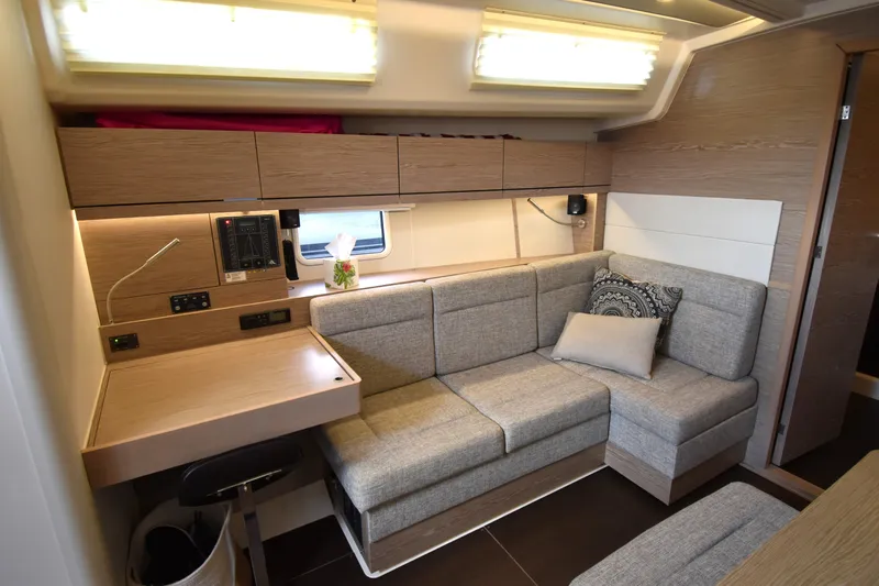 Maelynn Rose Yacht Photos Pics Modern interior of 2019 Hanse 458 yacht with cozy seating and desk area.