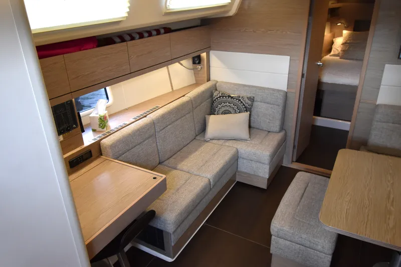 Maelynn Rose Yacht Photos Pics Modern interior of 2019 Hanse 458 yacht with cozy seating and wooden accents.