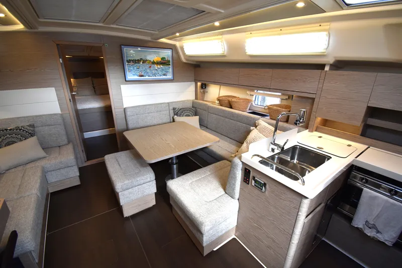 Maelynn Rose Yacht Photos Pics Luxurious 2019 Hanse 458 yacht interior with modern kitchen and cozy seating area.