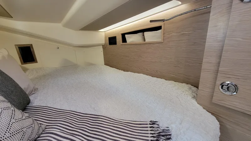 Maelynn Rose Yacht Photos Pics Cozy cabin interior of 2019 Hanse 458 yacht with modern bedding and storage.