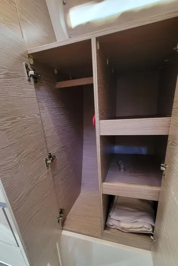 Maelynn Rose Yacht Photos Pics 2019 Hanse 458 yacht interior wooden storage cabinet with shelves.