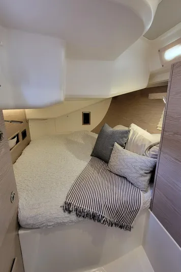 Maelynn Rose Yacht Photos Pics Cozy cabin interior of 2019 Hanse 458 yacht with bed and cushions.