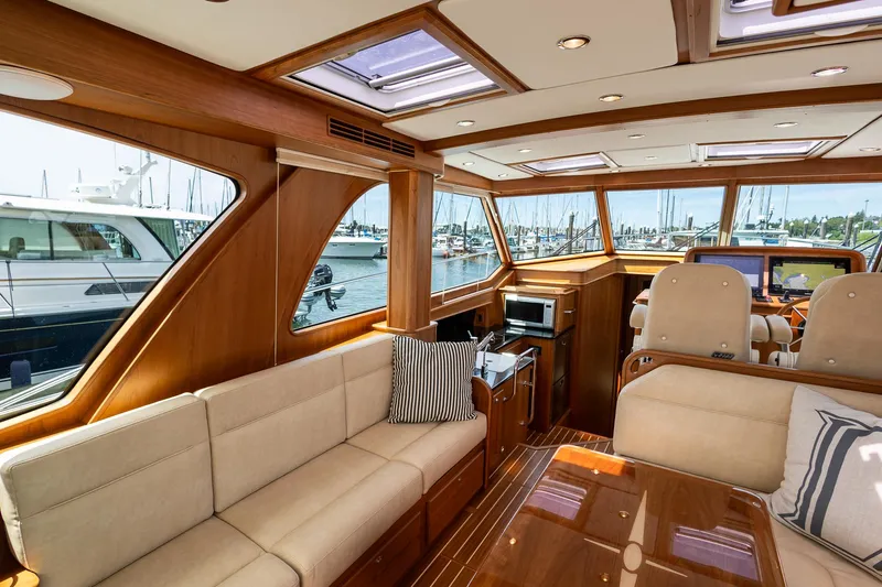 Luca Yacht Photos Pics Interior of 2023 Sabre 43 Salon Express yacht with luxurious seating and large windows.