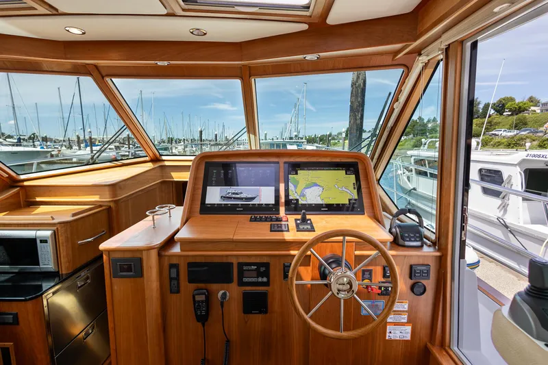 Luca Yacht Photos Pics 2023 Sabre 43 Salon Express helm with navigation screens and marina view.