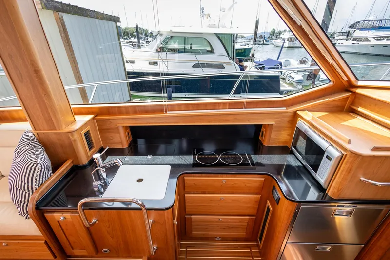 Luca Yacht Photos Pics 2023 Sabre 43 Salon Express yacht kitchen with modern appliances and wood cabinetry.