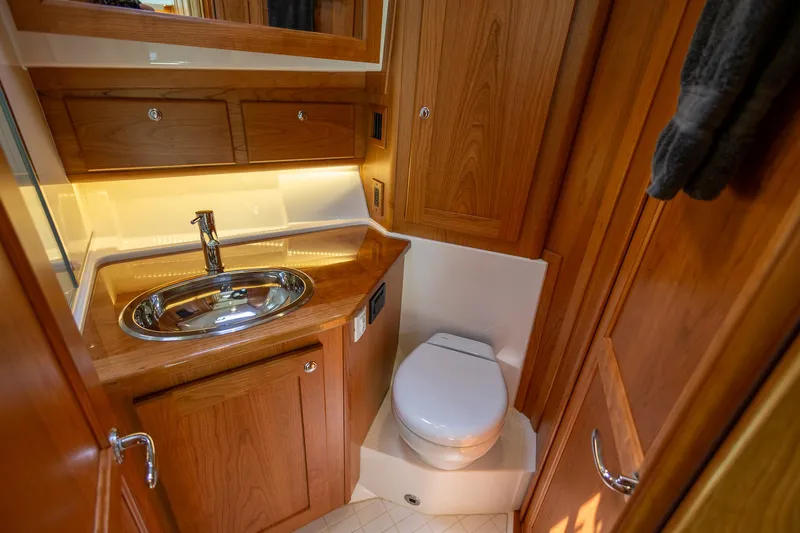 Luca Yacht Photos Pics 2023 Sabre 43 Salon Express bathroom with wooden cabinetry and modern fixtures.