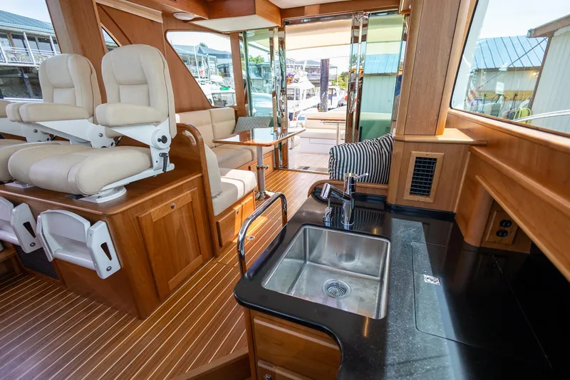 Luca Yacht Photos Pics Interior of 2023 Sabre 43 Salon Express yacht with helm seats and kitchenette.