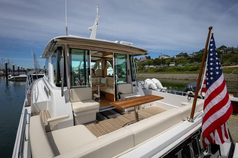 Luca Yacht Photos Pics 2023 Sabre 43 Salon Express yacht with American flag at dock.