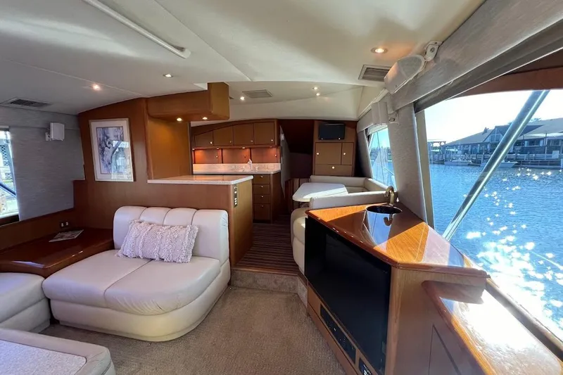 Reel Interest Yacht Photos Pics Luxurious interior of a 2002 Ocean Yachts 56 Super Sport with elegant furnishings and waterfront view.