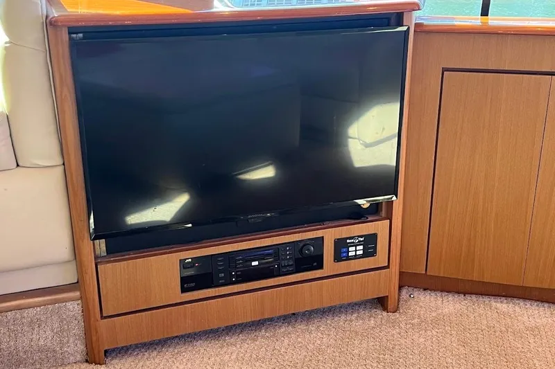 Reel Interest Yacht Photos Pics Entertainment system on 2002 Ocean Yachts 56 Super Sport, featuring a TV and audio controls.