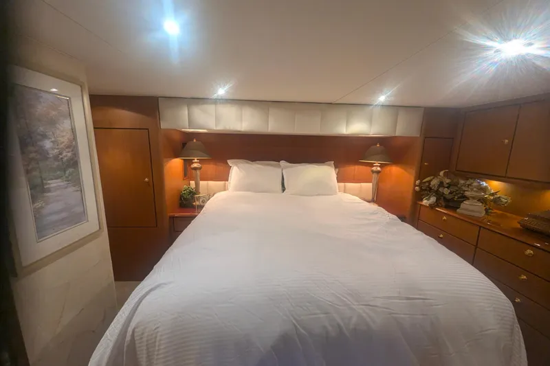 Reel Interest Yacht Photos Pics Luxurious bedroom interior of 2002 Ocean Yachts 56 Super Sport with elegant lighting and decor.