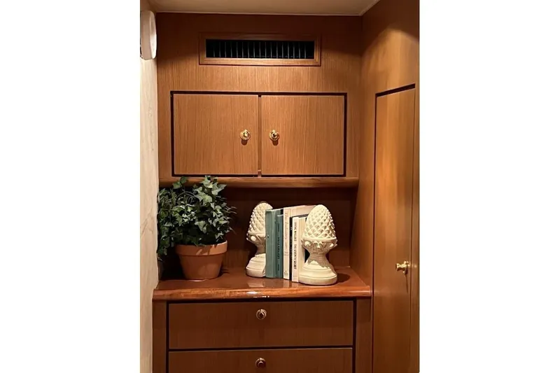 Reel Interest Yacht Photos Pics Interior of 2002 Ocean Yachts 56 Super Sport with wooden cabinetry and decorative items.