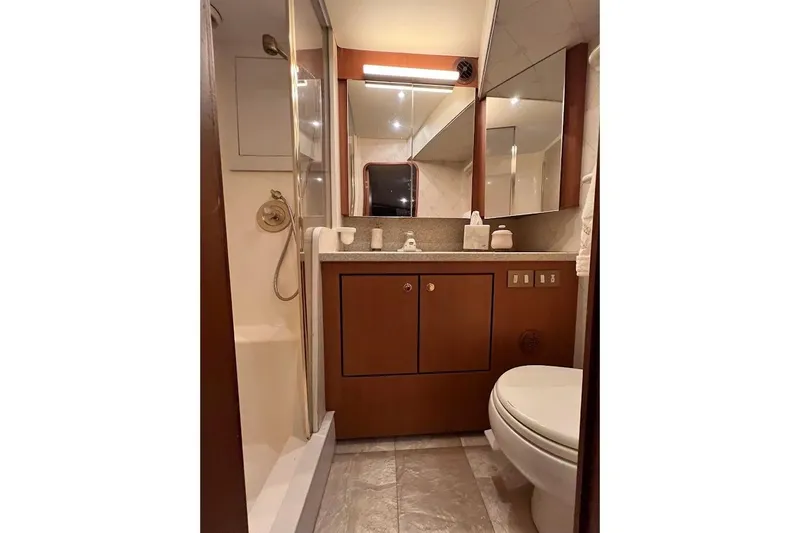 Reel Interest Yacht Photos Pics Luxurious bathroom in 2002 Ocean Yachts 56 Super Sport, featuring elegant wood cabinetry.