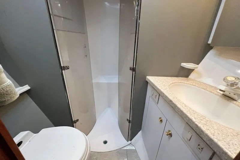 Reel Interest Yacht Photos Pics Bathroom interior of 2002 Ocean Yachts 56 Super Sport with shower and sink.