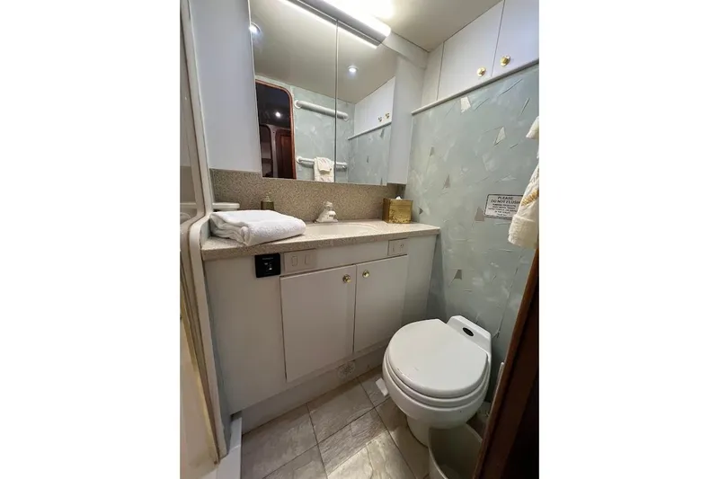 Reel Interest Yacht Photos Pics Luxurious bathroom in 2002 Ocean Yachts 56 Super Sport, featuring modern fixtures and elegant design.