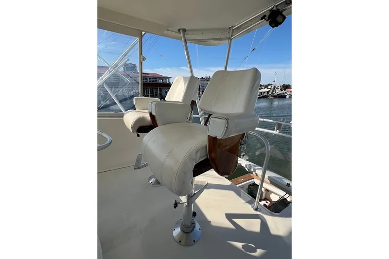 Reel Interest Yacht Photos Pics Captain's chairs on 2002 Ocean Yachts 56 Super Sport, overlooking marina.