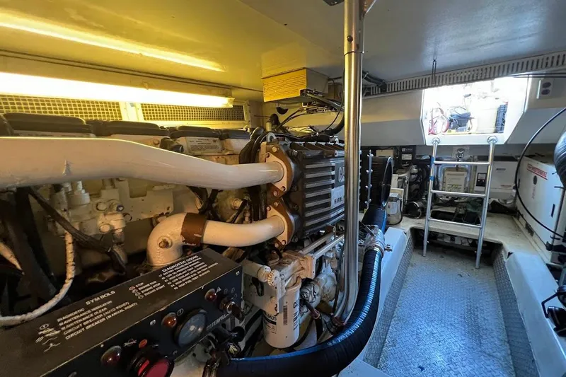 Reel Interest Yacht Photos Pics Engine room of 2002 Ocean Yachts 56 Super Sport, featuring Caterpillar marine engine.