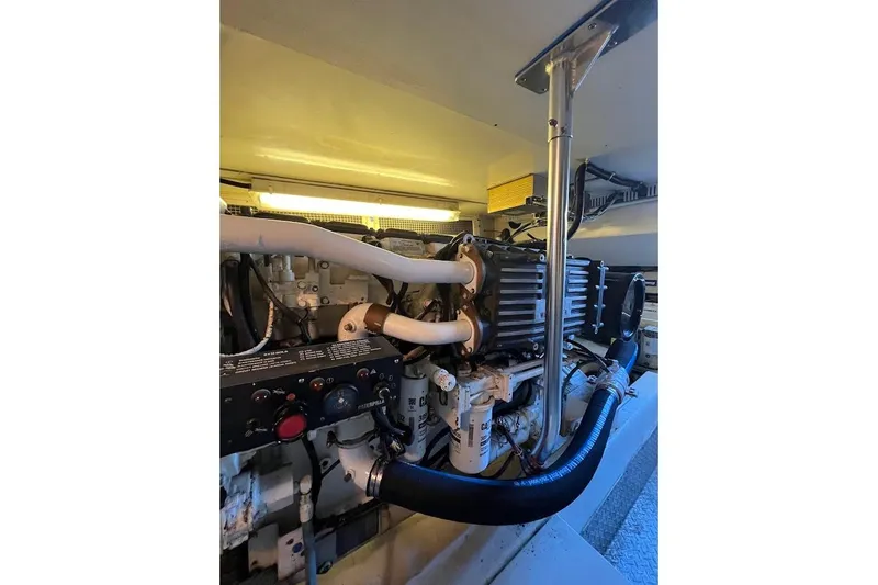 Reel Interest Yacht Photos Pics Engine room of 2002 Ocean Yachts 56 Super Sport, showcasing mechanical components and piping.
