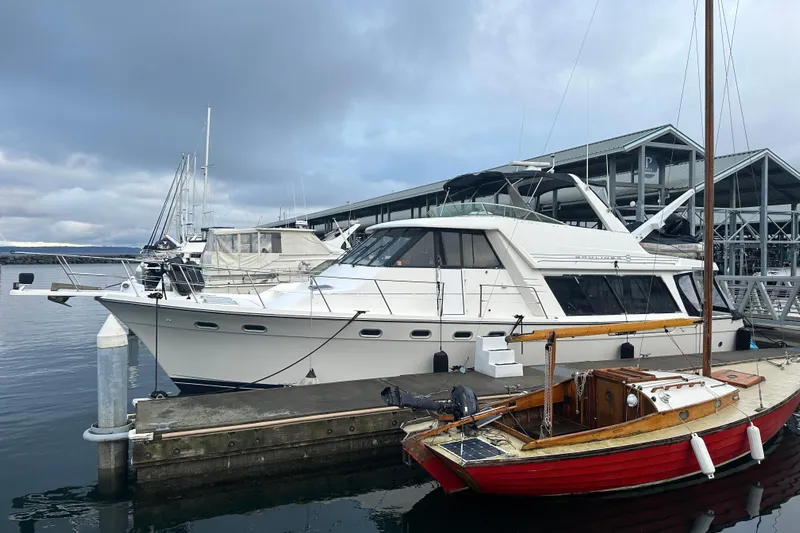 Stacey Lee Yacht Photos Pics 1999 Bayliner 4788 Pilot House Motoryacht docked at marina under cloudy sky.