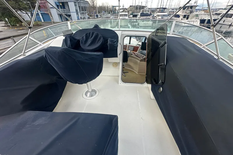 Stacey Lee Yacht Photos Pics 1999 Bayliner 4788 Pilot House Motoryacht deck with covered seating and helm station.