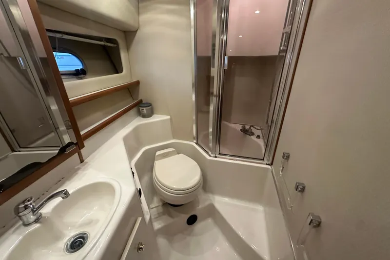 Stacey Lee Yacht Photos Pics Bathroom of 1999 Bayliner 4788 Pilot House Motoryacht with shower, sink, and toilet.