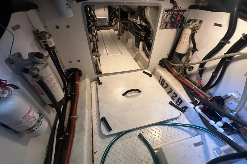 Stacey Lee Yacht Photos Pics Engine room of 1999 Bayliner 4788 Pilot House Motoryacht with visible equipment and wiring.