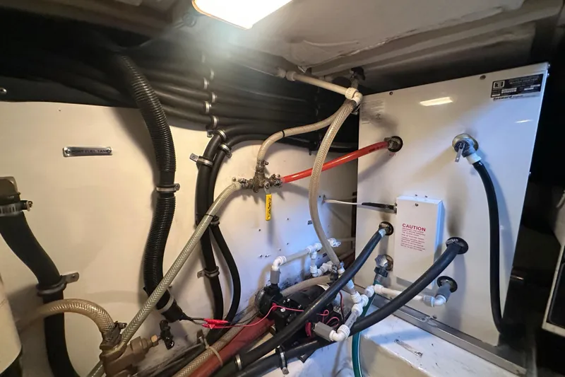 Stacey Lee Yacht Photos Pics Engine room of 1999 Bayliner 4788 Pilot House Motoryacht with fuel and water hoses.