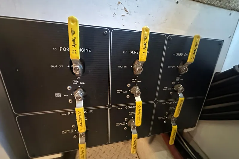 Stacey Lee Yacht Photos Pics Control panel of a 1999 Bayliner 4788 Pilot House Motoryacht with labeled yellow levers.