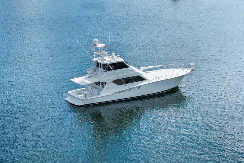 Sand Control Yacht Photos Pics 2002 Hatteras 60 Convertible yacht on calm blue water.