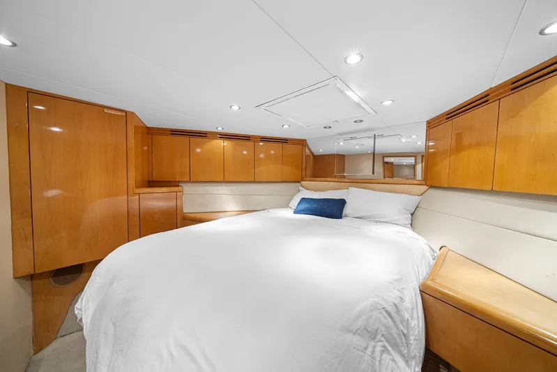 Sand Control Yacht Photos Pics Luxurious bedroom interior of 2002 Hatteras 60 Convertible yacht with wood cabinetry.