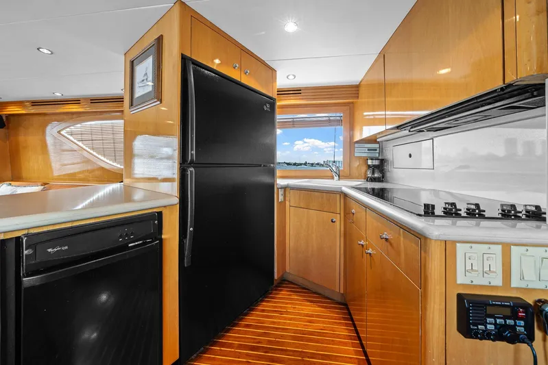 Sand Control Yacht Photos Pics Luxurious kitchen interior of 2002 Hatteras 60 Convertible yacht with modern appliances.
