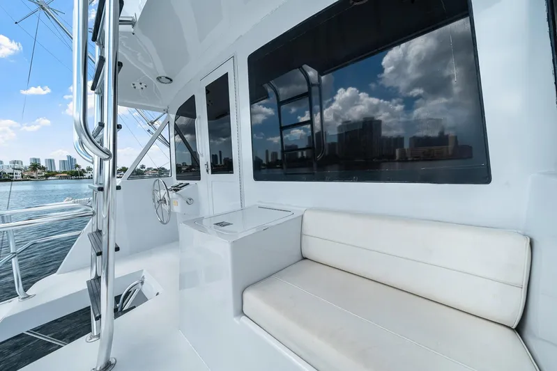 Sand Control Yacht Photos Pics 2002 Hatteras 60 Convertible yacht interior with seating and water view.