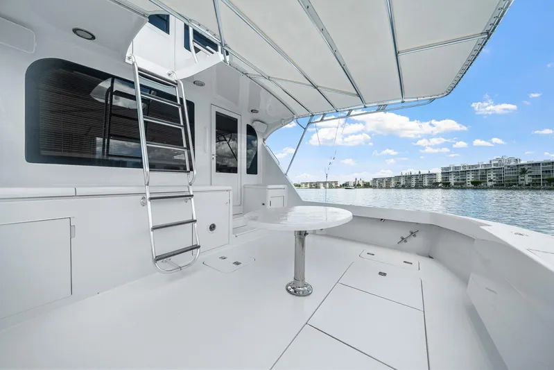 Sand Control Yacht Photos Pics Spacious deck of 2002 Hatteras 60 Convertible yacht with ladder and table.