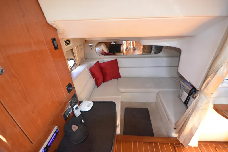  Yacht Photos Pics Interior of 2006 Regal Commodore 3560 yacht with cozy seating and red cushions.