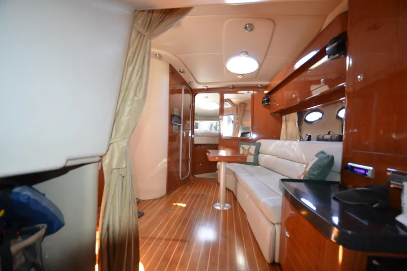  Yacht Photos Pics Interior of 2006 Regal Commodore 3560 yacht with elegant wood finish and seating area.