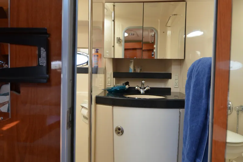  Yacht Photos Pics 2006 Regal Commodore 3560 yacht bathroom with mirror, sink, and towel.