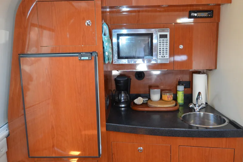  Yacht Photos Pics 2006 Regal Commodore 3560 yacht kitchenette with microwave, fridge, and sink.