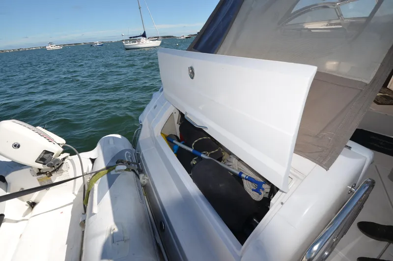  Yacht Photos Pics 2006 Regal Commodore 3560 yacht with open storage compartment and inflatable boat on water.