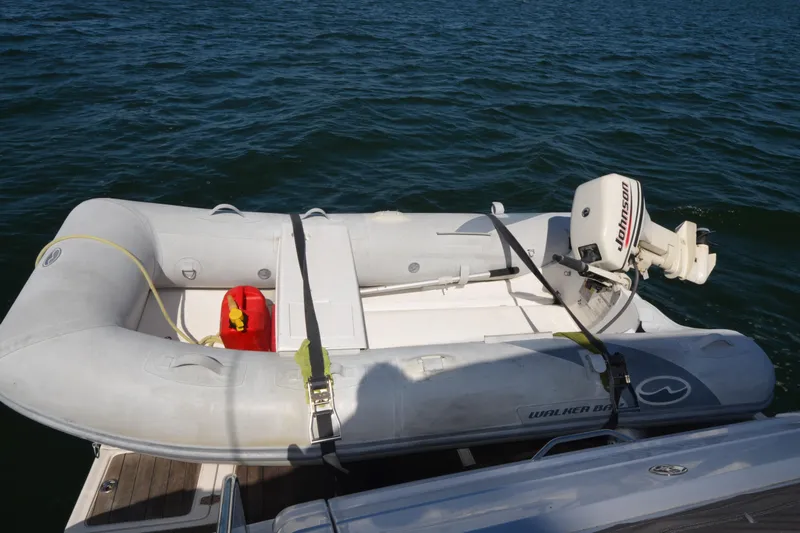  Yacht Photos Pics Inflatable boat with Johnson motor on water, near 2006 Regal Commodore 3560.