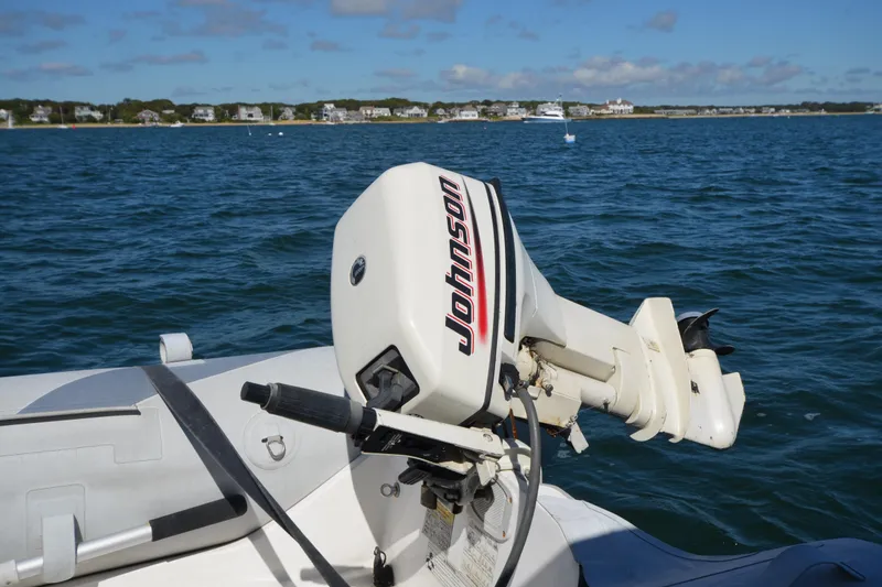  Yacht Photos Pics Outboard motor on a 2006 Regal Commodore 3560 boat, with coastal background.