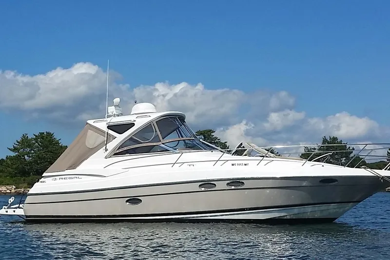  Yacht Photos Pics 2006 Regal Commodore 3560 yacht on calm water under a clear blue sky.